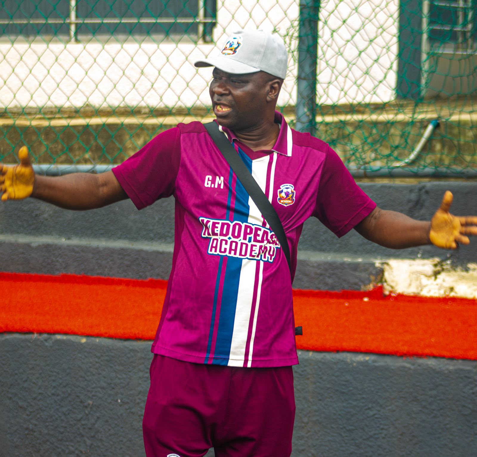 KEDOPEACH Academy coach directing players from the sideline