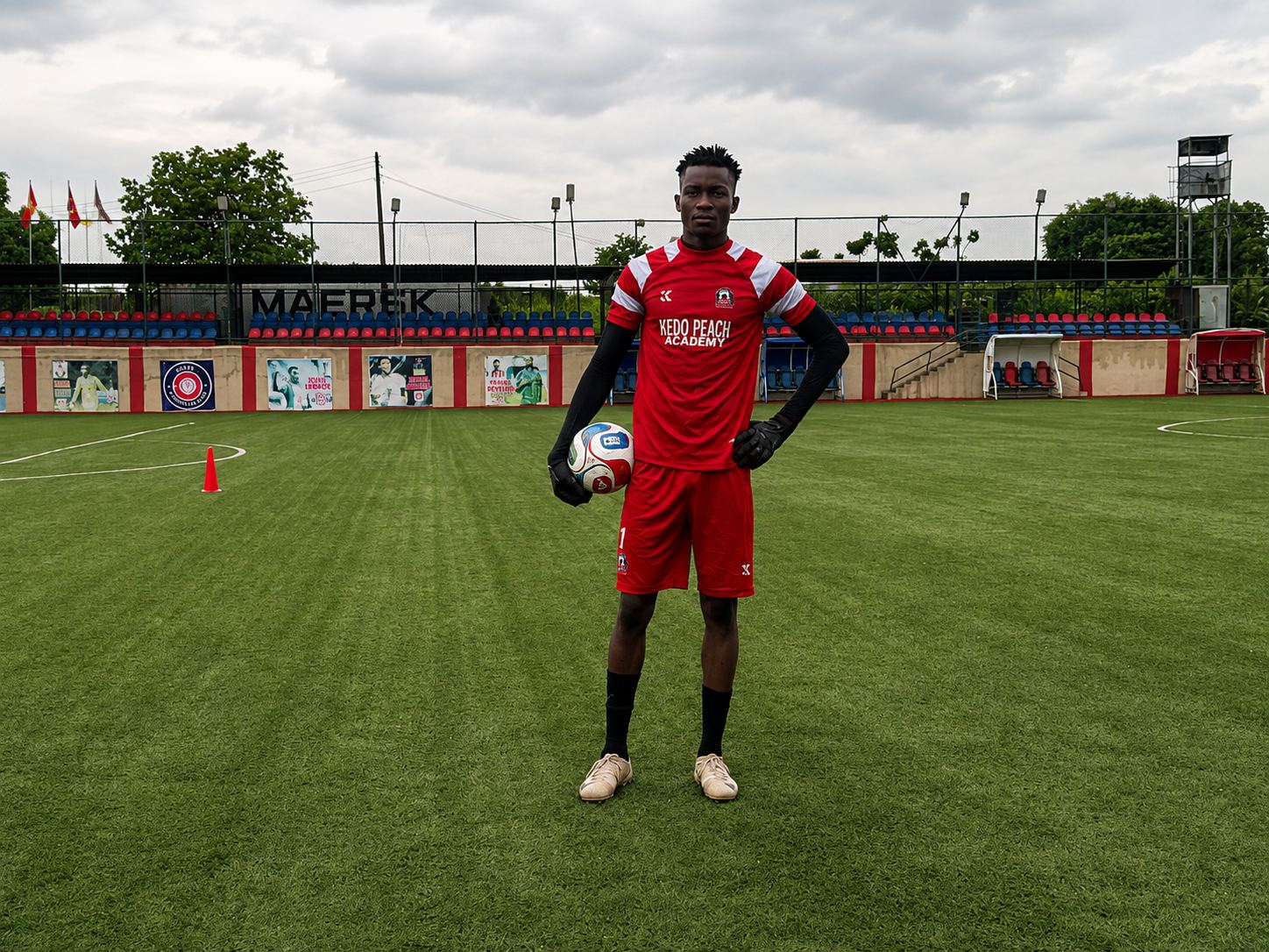 KEDOPEACH goalkeeper in academy kit holding a football